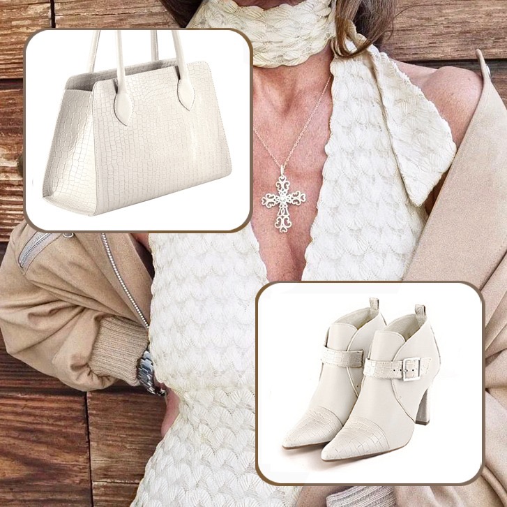 Women's elegant ankle boots, with buckles at the front, and medium luxurious handbag to pair with an off white outfit.