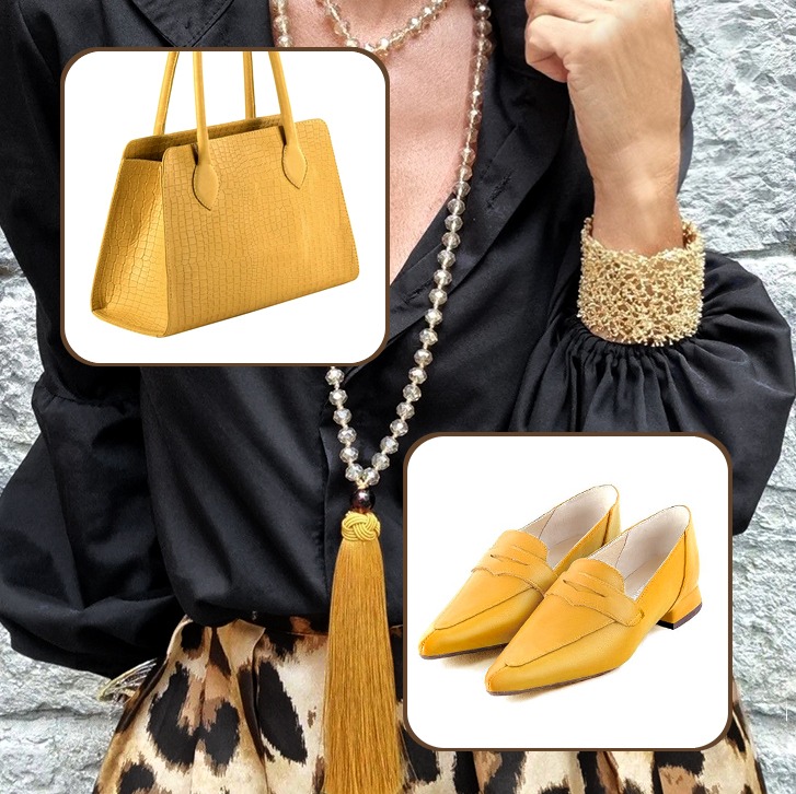 Women's medium luxurious handbag and classic elegant loafers to pair with a mustard yellow outfit.