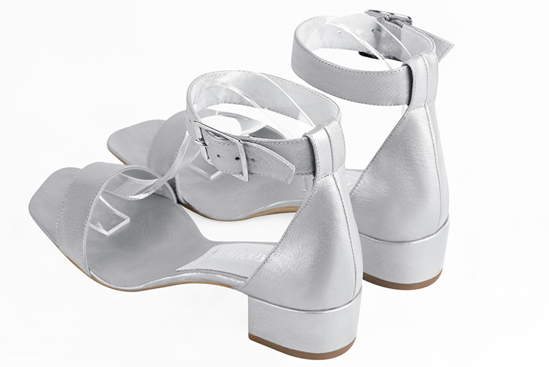 Light silver women's closed back sandals, with a strap around the ankle. Square toe. Low block heels. Rear view - Florence KOOIJMAN