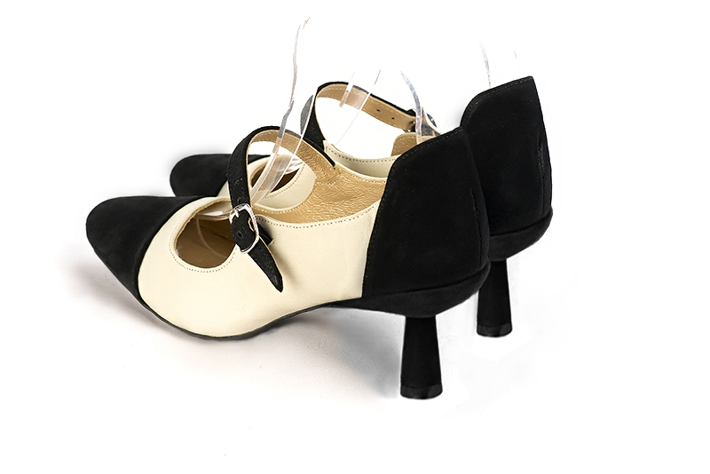 Matt black and off white women's dress pumps, with a round neckline. Round toe. Medium spool heels. Rear view - Florence KOOIJMAN