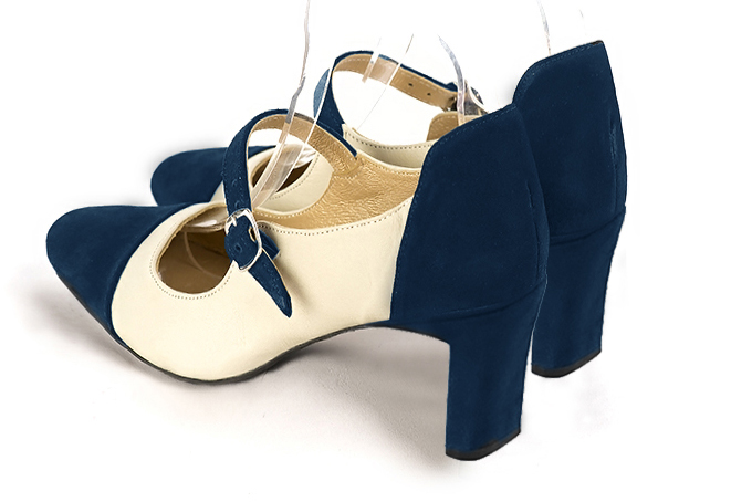 Navy blue and off white women's dress pumps, with a round neckline. Round toe. Medium comma heels. Rear view - Florence KOOIJMAN