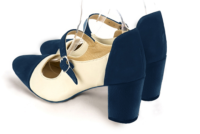 Navy blue and off white women's dress pumps, with a round neckline. Round toe. Medium block heels. Rear view - Florence KOOIJMAN