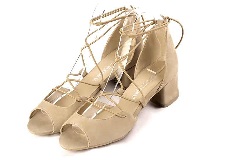 Sand beige women's closed back sandals, with crossed straps. Round toe. Low flare heels. Front view - Florence KOOIJMAN