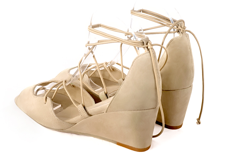 Sand beige women's closed back sandals, with crossed straps. Round toe. Medium wedge heels. Rear view - Florence KOOIJMAN