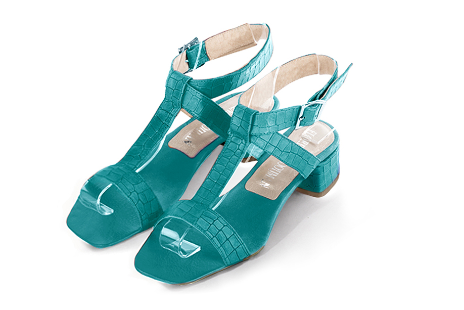 Dress sandals instep strap fully open in turquoise blue leather with low flare heels and square toe - Front view