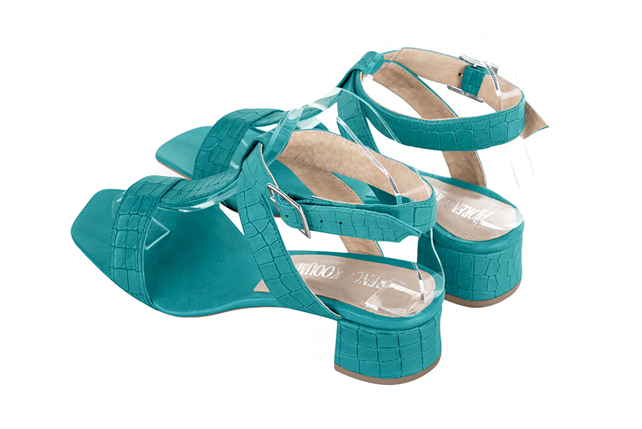 Dress sandals instep strap fully open in turquoise blue leather with low flare heels and square toe - Rear view