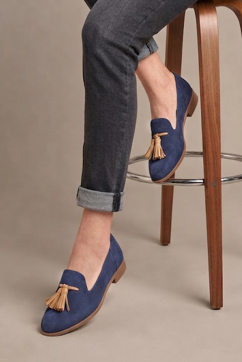 Women's indigo blue and camel tassel loafers with round toe and chunky rubber lug sole - Worn view
