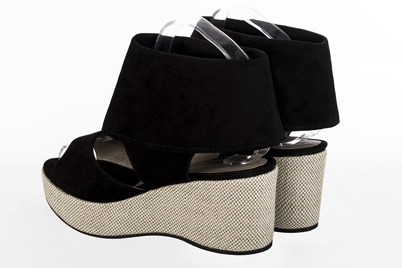 Matt black women's fully open sandals, with an instep strap. Round toe. Medium wedge soles. Rear view - Florence KOOIJMAN